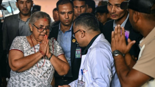 Nepal returns to calm as first woman PM takes charge, visits wounded