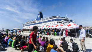 Pressure eases as Italian island begins migrant transfer to Sicily