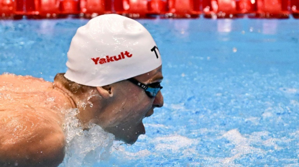 Record-breaker Marchand back in action at swimming world championships