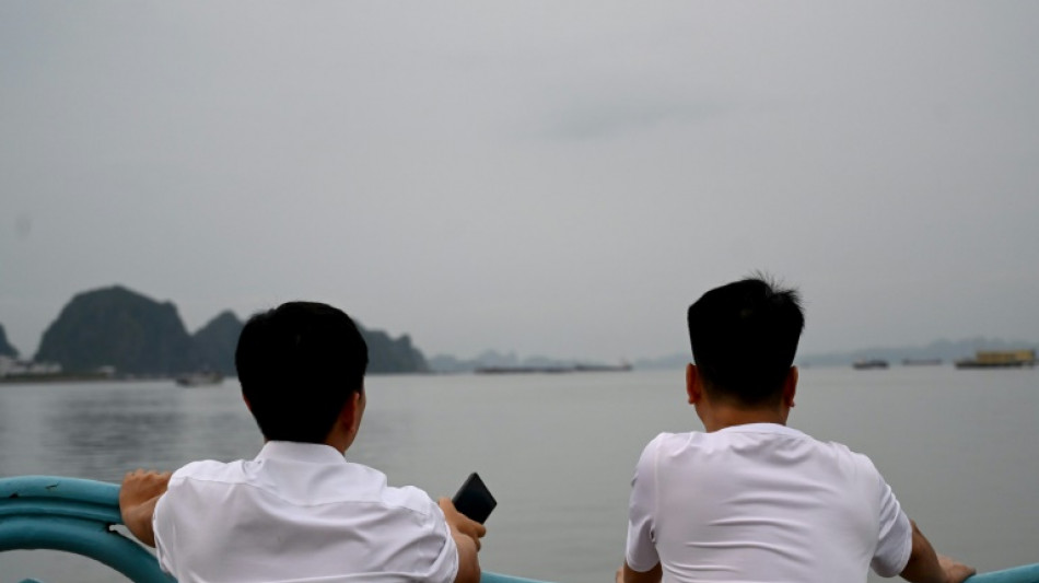 Tearful relatives await news from Vietnam wreck rescue